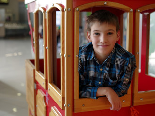 Portrait of happy smiling teenage boy in the wood wagon train