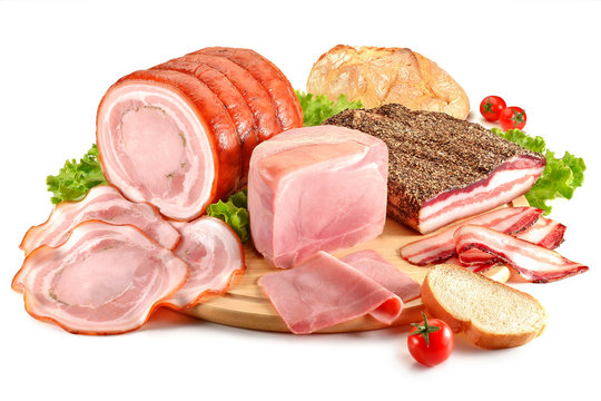 Fototapeta Cutting board with pork, bacon, ham and bread