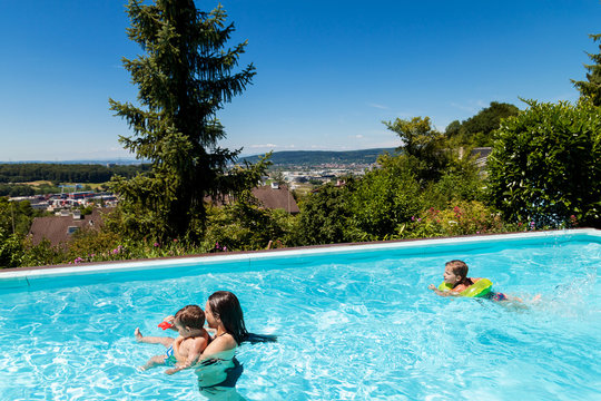 children swimming in the swimming pool in the garden