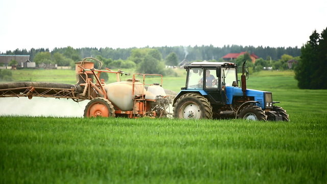 Tractors sprayed with fertilizer grass on the field