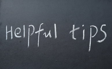 Obraz premium helpful tips text write on blackboard