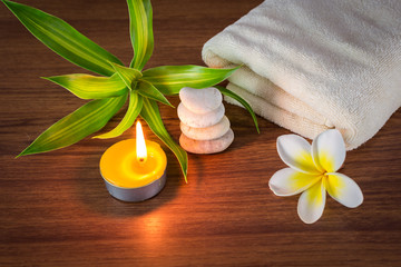 Fototapeta na wymiar Spa still life with aromatic candles,flower and towel