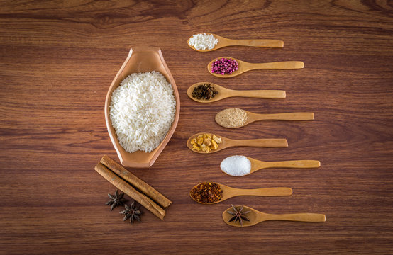 spice and herb in spoons on wooden background.