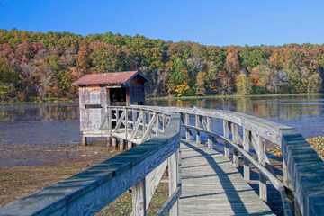 Fototapeta na wymiar Boat house on a peaceful lake in autumn