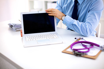 Doctor working with laptop computer in medical workspace office
