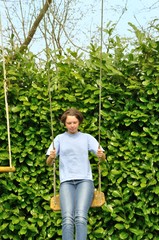 A girl playing in a swing