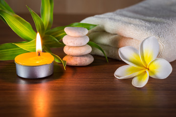 Fototapeta na wymiar Spa still life with aromatic candles,flower and towel