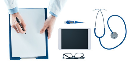 Doctor writing a prescription on a clipboard