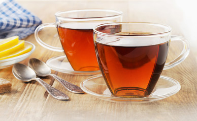Glass cups of  black tea with lemon.