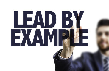 Businessman pointing the text: Lead By Example