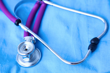 A stethoscope shaping a heart and a clipboard on a medical