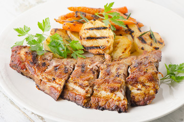 Grilled Pork Ribs and Potatoes on a Plate.