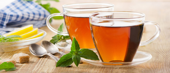 Cups of tea with mint leaves and lemon. © bit24