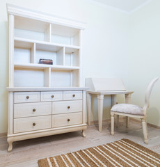 Vintage cabinet, desk and chair in a room