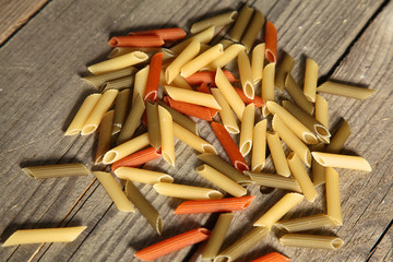 Raw homemade pasta and ingredients for pasta on wooden