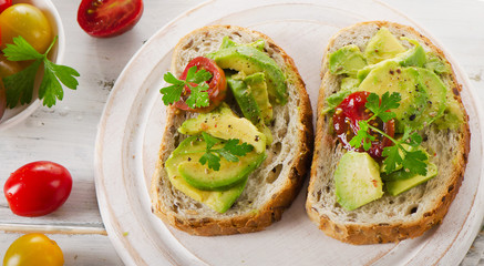 Homemade sandwiches with avocado and tomato.