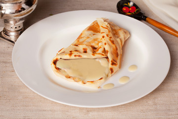 Pancakes with condensed milk in a rustic still life rural county