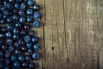 blueberries collected manually scattered on the old board.