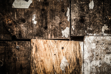 Old boards in an old house with the remains of old newspapers. S