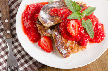 Pancakes with strawberry jam and mint.