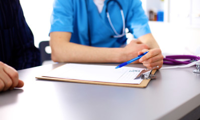 close up of patient and doctor taking notes