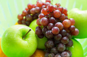 Apple, grapes and orange in the basket