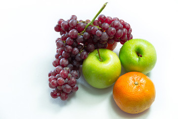 Apple, grapes and oranges on white background