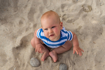 Little baby boy on the beach, playing