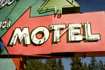 aged and worn vintage photo of neon motel sign
