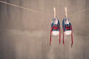Baby shoes hanging on the clothesline