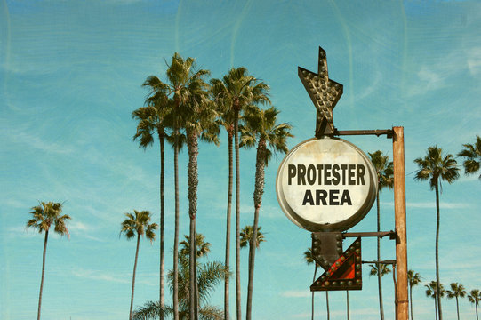 aged and worn vintage photo of protester area sign