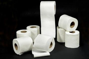 White rolls of toilet paper with embossed decorative patterns