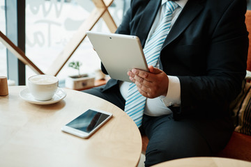 Working in coffee shop. Close up view cropped image of thoughtfu