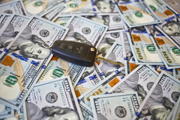 Car key on a background of dollars. Business concept