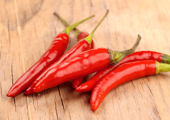 whole red chillies on rustic wood