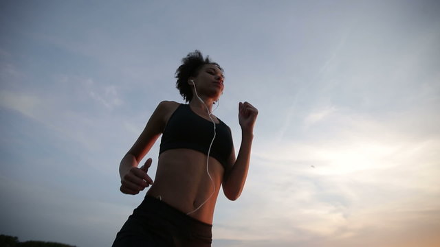 Woman runner running at sunrise