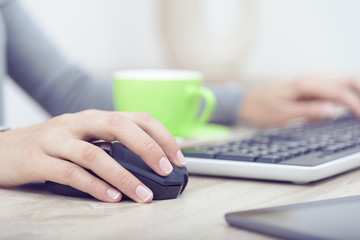 Woman's hands on a keyboard.