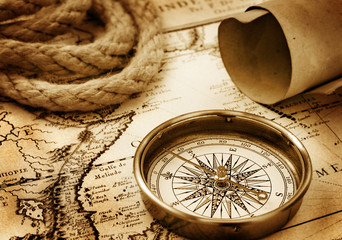 Vintage compass, rope and paper sroll on map