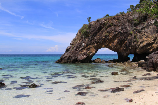 Natural stone arch with beautiful beach at Kho Khai , Thailand
