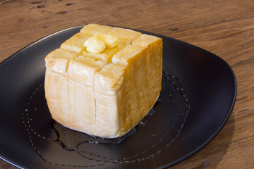 The original honey toast on black dish