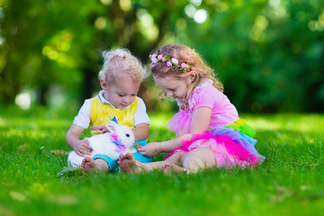 Kids playing with pet rabbit