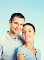 Cheerful young couple, over blue