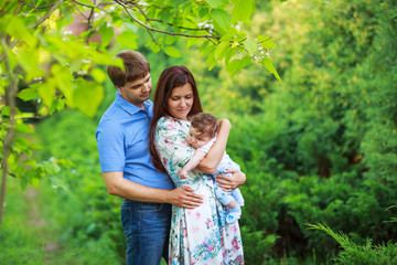 parents with baby son, close-up, summer