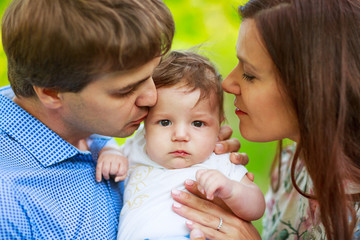 parents with baby son, close-up, summer