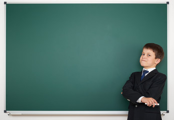 school boy on empty board background