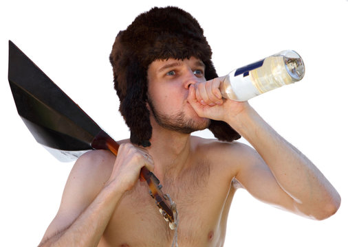 Russian man in fur hat with balalaika drinks vodka from bottle