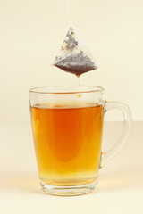 Tea bags over the glass with brewed tea
