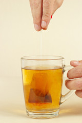 Hands brewed strong fresh tea in a glass