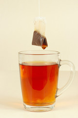 Tea bags over the glass with fresh fragrant tea