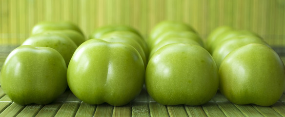 Grüne Tomaten vor grünem Hintergrund